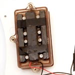 Underside of a (early clear-covered) Gibson Marauder humbucker mounted to the scratchplate